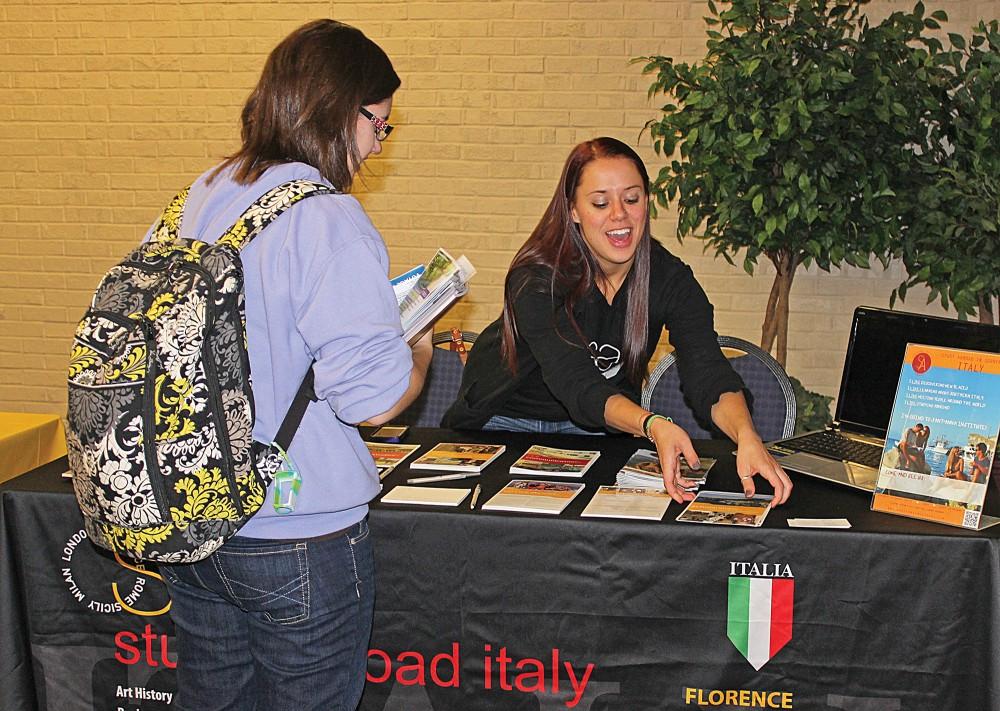 GVL / Laine GirardAmanda Furstenburg handing out information to students interested in Studying Abroad in Italy.  