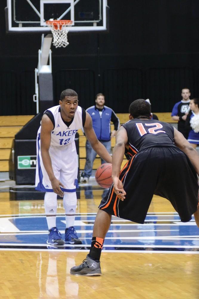 GVL Archive / Hannah Mico. 
Rob Woodson (senior) checks the court for an open path to Findlay's basket.