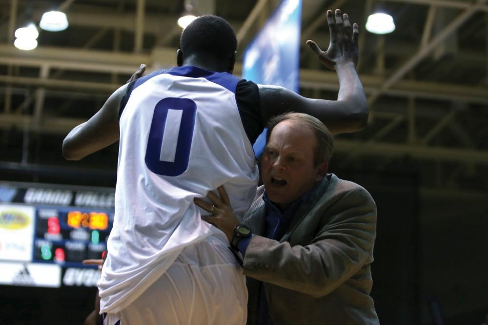 GVL / Robert Mathews
Head Coach Ric Wesley holds back Darren Washington during an altercation against Lake Superior State