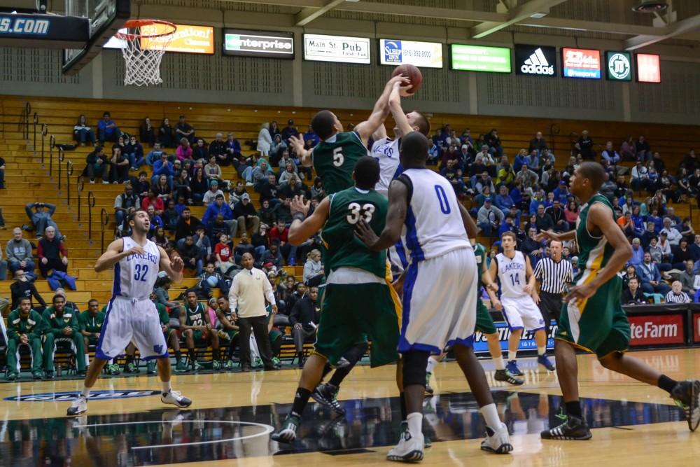 GVL / Hannah Mico. Ryan Sabin attempting a basket through a strong defensive line from Wayne State.