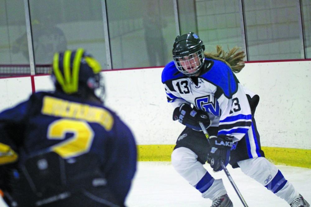 GVL/ Emily Frye 
Senior Jordyn Moore trys to move the puck past the Wolverine's