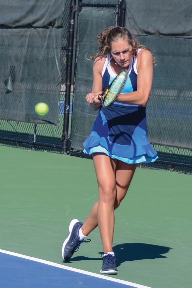 GVL / Hannah Mico. Senior Lexi Rice focuses hard on returning a volley at Saturday morning's match against Wayne State University; Rice was playing doubles with her partner Carola Orna (junior).
