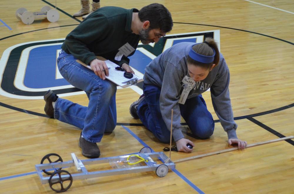 GVL / Nate Kalinowski
Professor Christopher Lawrence and Freshmen Gabrielle Gomez measure to see how well at team did in the wheeled vehicle event.
