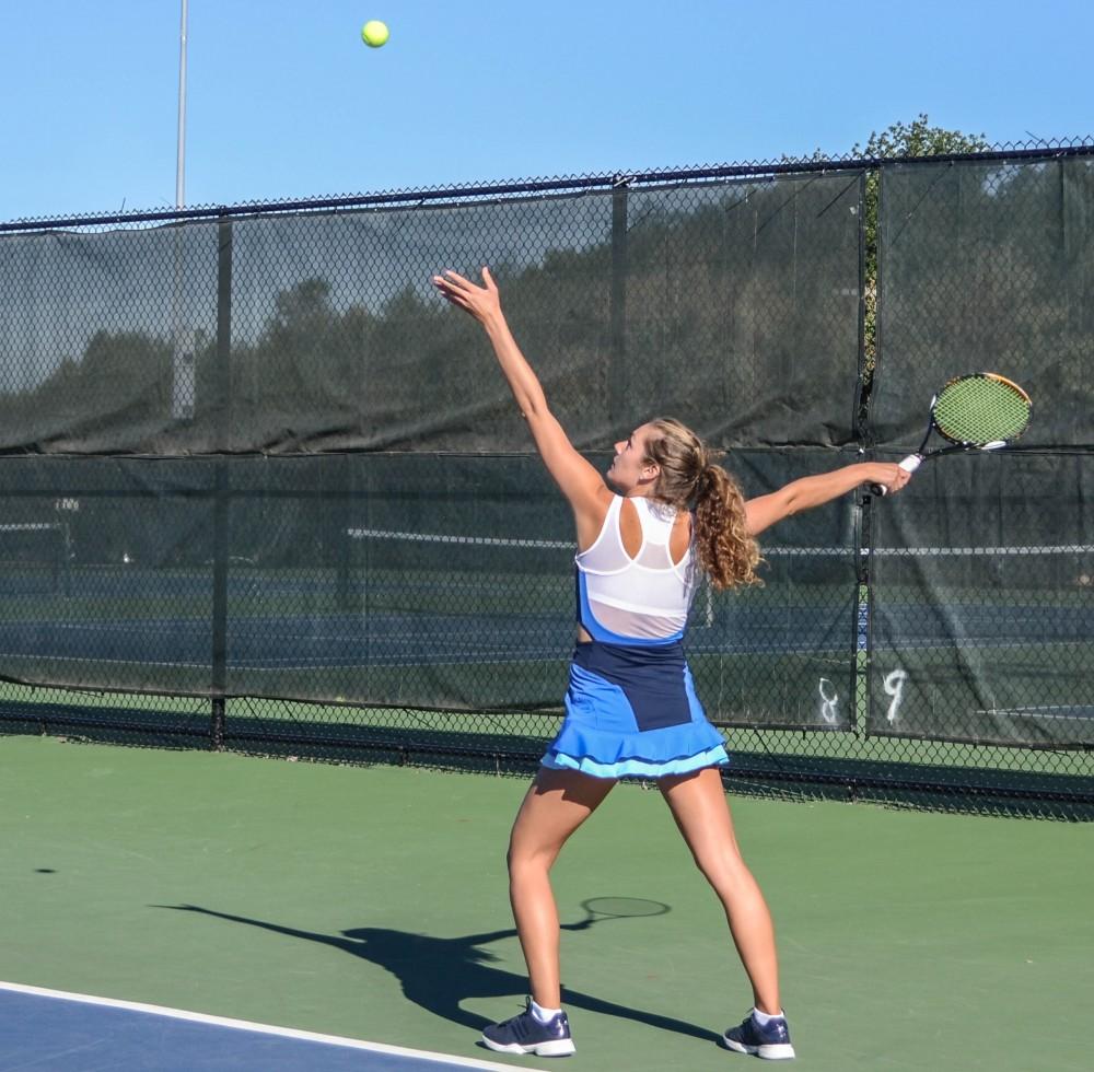 GVL / Hannah Mico. Senior Lexi Rice makes an impressive serve during Saturday mornings match against Wayne State University; Rice was playing doubles with her partner Carola Orna (junior).