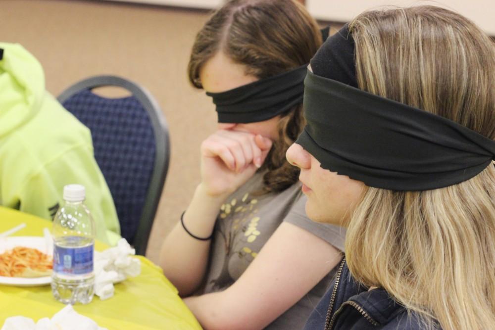GVL / Laine GirardBlind folded students experience the feeling of not being able to see during an event called Dinner In the Dark.
