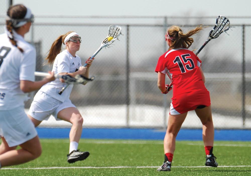 GVL / Hannah Mico. Junior attack Zoe Stiemann dodges a defensive player from Roberts Wesleyan to make it to the goal.