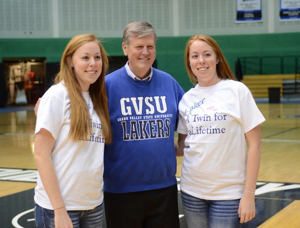 GVL/Kevin SielaffKaylee and Allison Tuin pose with President Haas during a celebration of twins in GVSU athletics, which took place this past Sunday inside the Fieldhouse. 