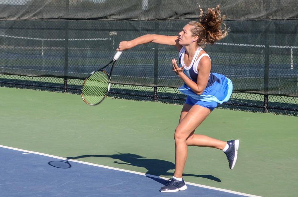 GVL / Hannah Mico. Senior Lexi Rice forehands the ball during Saturday morning's match against Wayne State University; Rice was playing doubles with her partner Carola Orna (junior).
