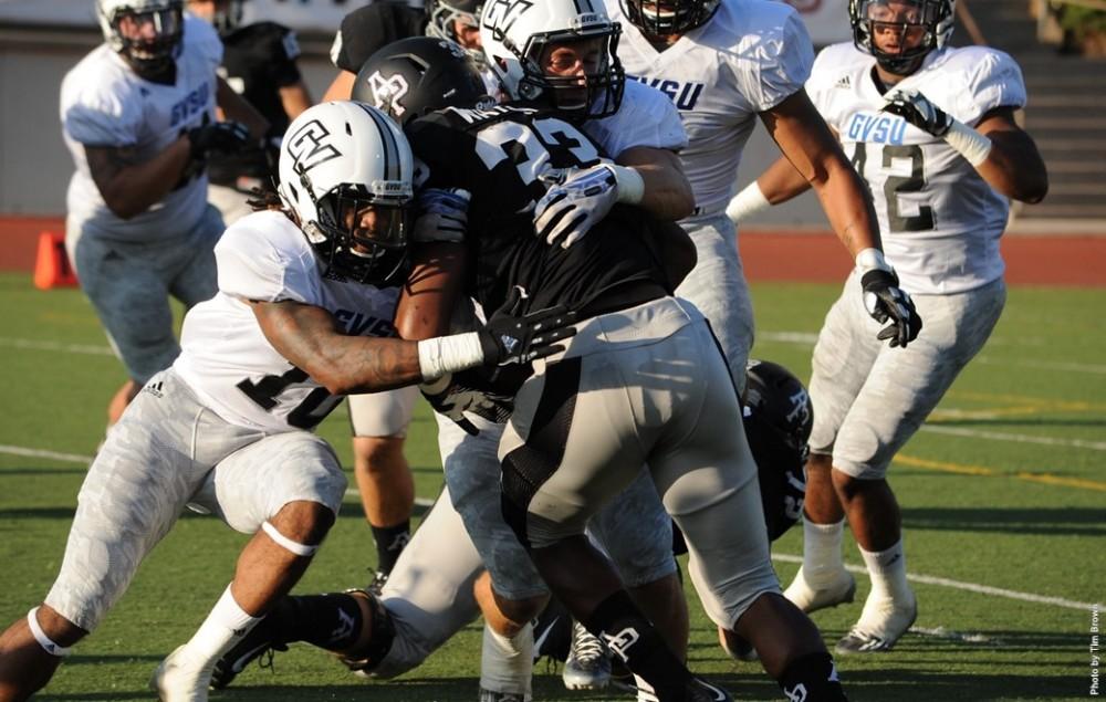 Azusa Pacific RB Terrell Watson collides with a pair of GVSU defenders on Thursday night.