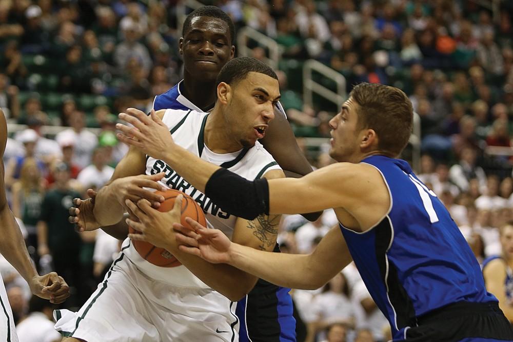 GVL / Robert Mathews        
Ernijs Ansons and Darron Washington attempt to strip the ball from Denzel Valentine