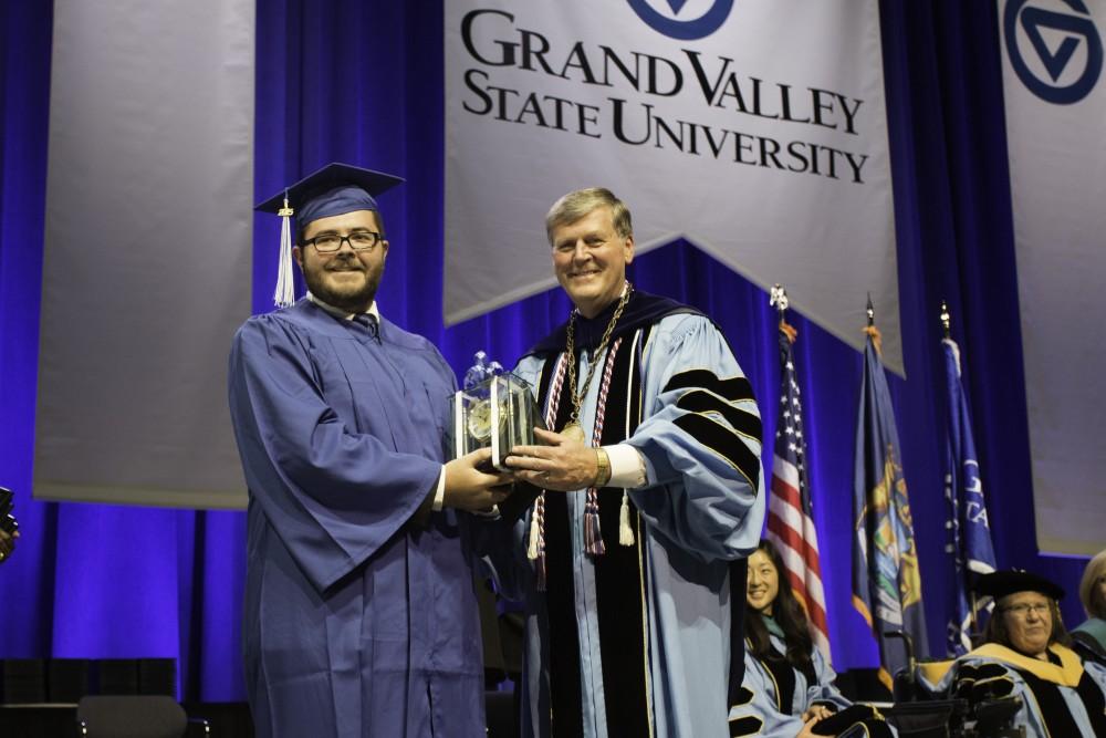 GVL/Spencer Miller
Dale Paul Boteker, Grand Valleys 100,000th graduate, stands with President T. Haas after recieving an award during the 2015 GVSU commencement ceremony on Saturday, April 25.