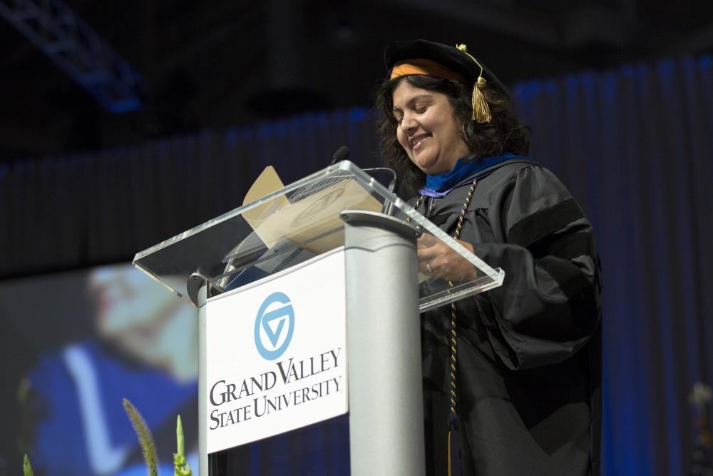 GVL / Kevin Sielaff
Samhita Rhodes, associate professor of engineering, speaks at convocation. Grand Valley kicks off the academic year with their annual convocation ceremonies, held August 29th, 2015 inside the Fieldhouse Arena.  