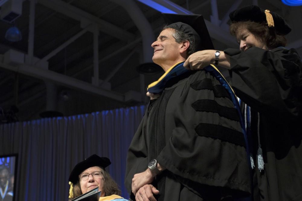 GVL / Kevin Sielaff
Dean Kamen receives an honorary degree during convocation. Grand Valley kicks off the academic year with their annual convocation ceremonies, held August 29th, 2015 inside the Fieldhouse Arena.  