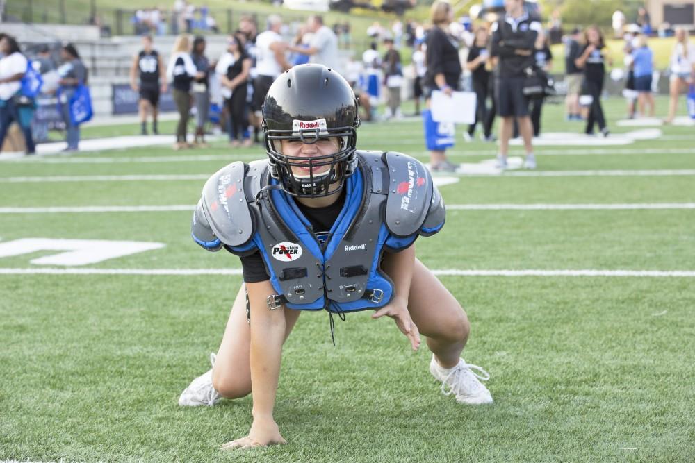 GVL / Kevin Sielaff
Student Jazz Moore suits up with full padding during Fan Fest. The Grand Valley State University athletics department hosts its annual Fan Fest at Lubbers Stadium Thursday, August 28th, 2015. Incoming freshman and athletes alike swarm the football field for games and activities in a "meet and greet" setting. 