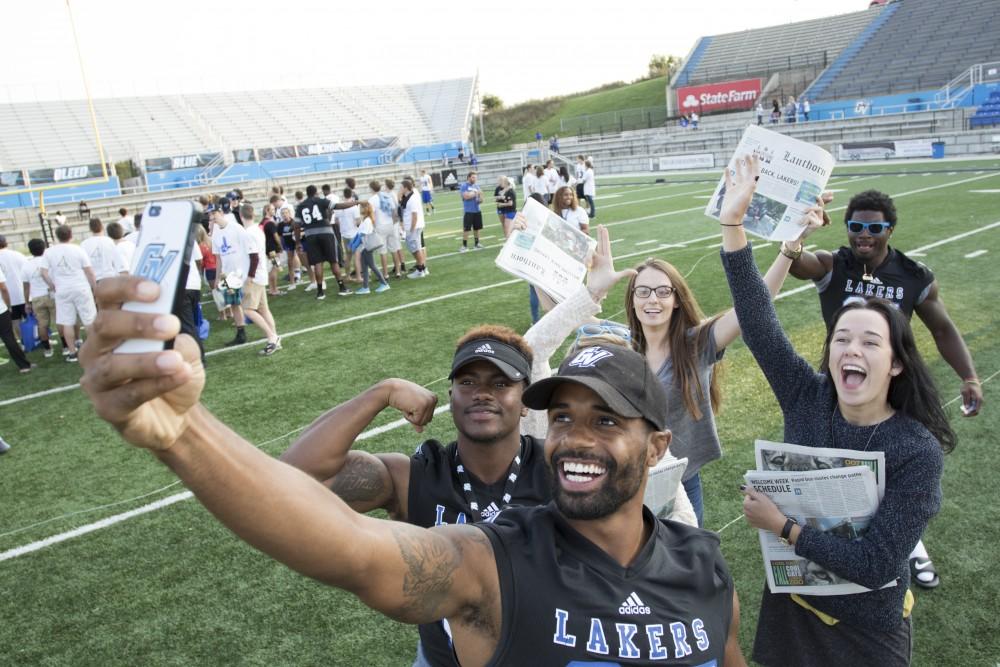 GVL / Kevin Sielaff
Running back Kirk Spencer takes a selfie with the Grand Valley Lanthorn marketing team. The Grand Valley State University athletics department hosts its annual Fan Fest at Lubbers Stadium Thursday, August 28th, 2015. Incoming freshman and athletes alike swarm the football field for games and activities in a "meet and greet" setting. 