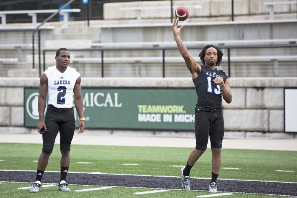 GVL / Kevin Sielaff
Justice Wright (13), wide receiver, throws a pass as teammates speak to the media. The Grand Valley State University football squad gathers for its annual media day Wednesday, August 19th, 2015. The afternoon aimed to promote the highly anticipated 2015 football season, while also making predictions for what the year ahead might hold.  