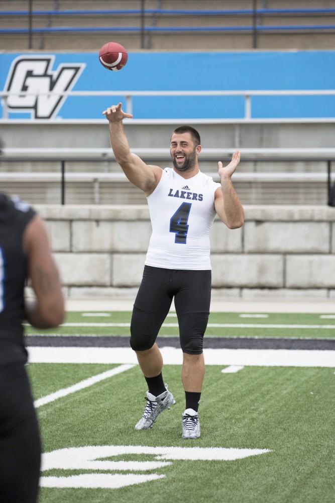 GVL / Kevin Sielaff
The Grand Valley State University football squad gathers for its annual media day Wednesday, August 19th, 2015. The afternoon aimed to promote the highly anticipated 2015 football season, while also making predictions for what the year ahead might hold. Alton Voss (4) tosses a football as media day comes to a close.  