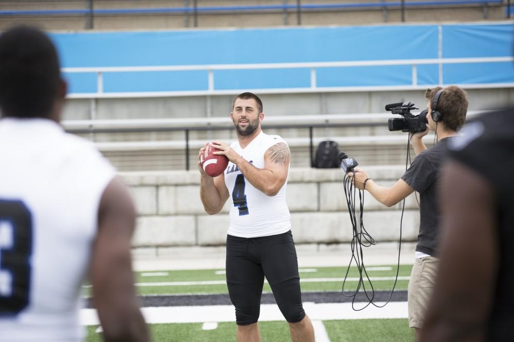 GVL / Kevin Sielaff
The Grand Valley State University football squad gathers for its annual media day Wednesday, August 19th, 2015. The afternoon aimed to promote the highly anticipated 2015 football season, while also making predictions for what the year ahead might hold. Alton Voss (4) looks to throw a pass to Matt Judon (9) as he is being interviewed by Grand Valley's sports info department. 