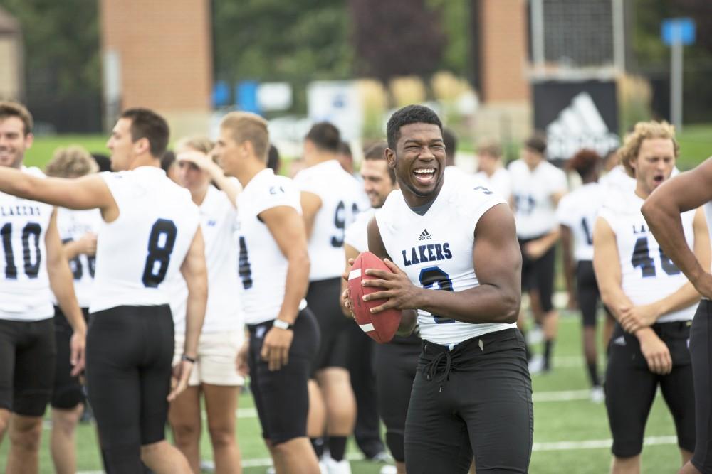 GVL / Kevin Sielaff
The Grand Valley State University football squad gathers for its annual media day Wednesday, August 19th, 2015. The afternoon aimed to promote the highly anticipated 2015 football season, while also making predictions for what the year ahead might hold. Brandon Bean (3) laughs and he receives the football.  