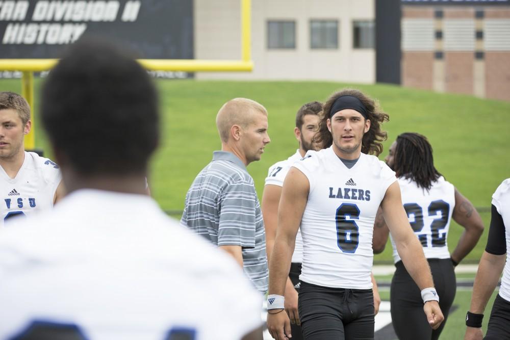 GVL / Kevin Sielaff
The Grand Valley State University football squad gathers for its annual media day Wednesday, August 19th, 2015. The afternoon aimed to promote the highly anticipated 2015 football season, while also making predictions for what the year ahead might hold. Quarterback Bart Williams (6) walks toward the media to be interviewed.   