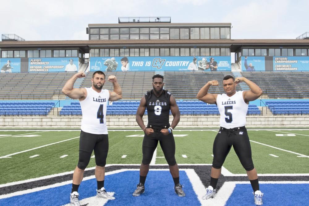 GVL / Kevin Sielaff
The Grand Valley State University football squad gathers for its annual media day Wednesday, August 19th, 2015. The afternoon aimed to promote the highly anticipated 2015 football season, while also making predictions for what the year ahead might hold.  Alton Voss (4), Matt Judon (9), and De'Ondre Hogan (5) all pose for a media day photo.  