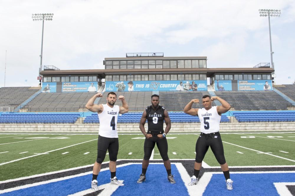 GVL / Kevin Sielaff
The Grand Valley State University football squad gathers for its annual media day Wednesday, August 19th, 2015. The afternoon aimed to promote the highly anticipated 2015 football season, while also making predictions for what the year ahead might hold.  Alton Voss (4), Matt Judon (9), and De'Ondre Hogan (5) all pose for a media day photo.  