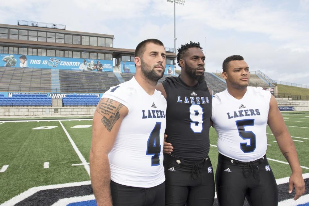 GVL / Kevin Sielaff
The Grand Valley State University football squad gathers for its annual media day Wednesday, August 19th, 2015. The afternoon aimed to promote the highly anticipated 2015 football season, while also making predictions for what the year ahead might hold.  Alton Voss (4), Matt Judon (9), and De'Ondre Hogan (5) all pose for a media day photo.  