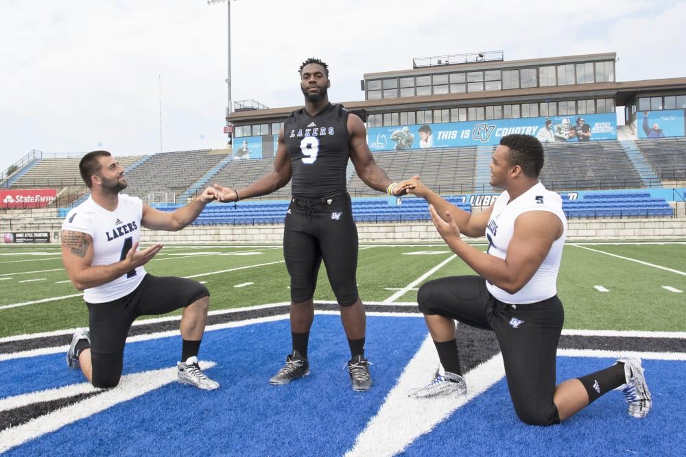 GVL / Kevin Sielaff
The Grand Valley State University football squad gathers for its annual media day Wednesday, August 19th, 2015. The afternoon aimed to promote the highly anticipated 2015 football season, while also making predictions for what the year ahead might hold.  Alton Voss (4), Matt Judon (9), and De'Ondre Hogan (5) all pose for a media day photo.  