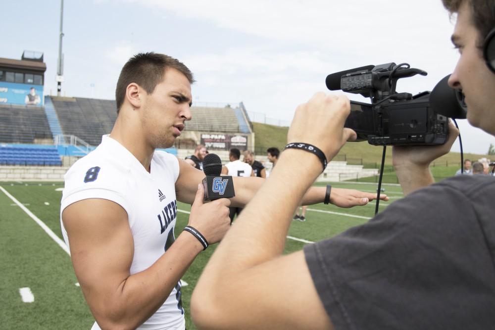 GVL / Kevin Sielaff
The Grand Valley State University football squad gathers for its annual media day Wednesday, August 19th, 2015. The afternoon aimed to promote the highly anticipated 2015 football season, while also making predictions for what the year ahead might hold. Joe Robbins (8), wide receiver, speaks to Grand Valley's sports info department.   