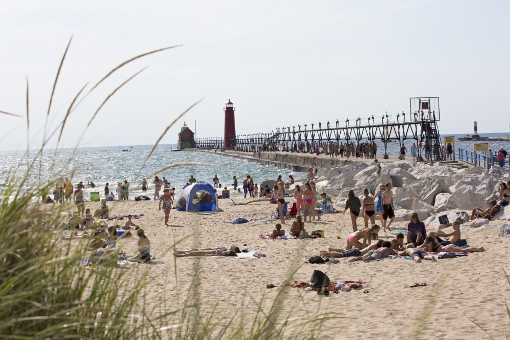 GVL / Kevin Sielaff    
Grand Haven State Park reaches its peak tourism season during mid-August as visitors benefit from the last of the summer's sun and waves - Saturday, August 22nd, 2015 drew massive crowds due to a cloudless sky and warm water temperatures. 