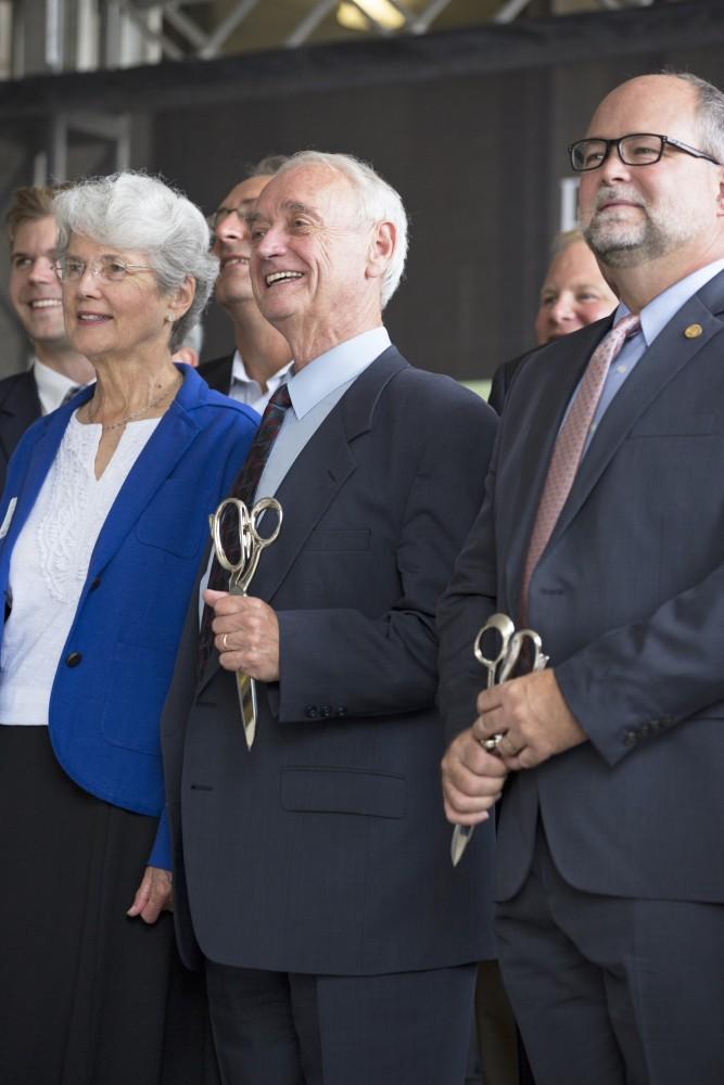 GVL / Kevin Sielaff
P. Douglas Kindschi cuts the ribbon in front of the new Kindschi Hall of Science. Grand Valley celebrates the P. Douglas Kindschi Hall of Science with a dedication ceremony Friday, August 28th, 2015. The dedication recognized both Grand Valley and state officials that made the realization of this building possible. 