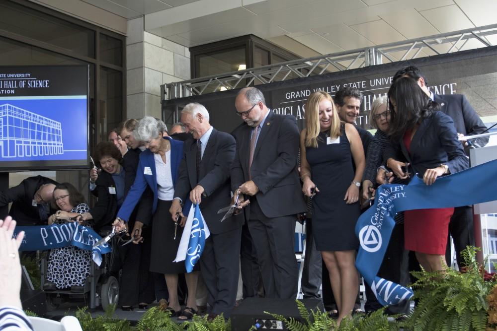 GVL / Kevin Sielaff
P. Douglas Kindschi and company cut the ribbon in front of the new Kindschi Hall of Science. Grand Valley celebrates the P. Douglas Kindschi Hall of Science with a dedication ceremony Friday, August 28th, 2015. The dedication recognized both Grand Valley and state officials that made the realization of this building possible. 