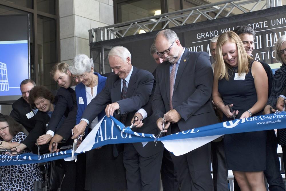 GVL / Kevin Sielaff
P. Douglas Kindschi and company cut the ribbon in front of the new Kindschi Hall of Science. Grand Valley celebrates the P. Douglas Kindschi Hall of Science with a dedication ceremony Friday, August 28th, 2015. The dedication recognized both Grand Valley and state officials that made the realization of this building possible. 