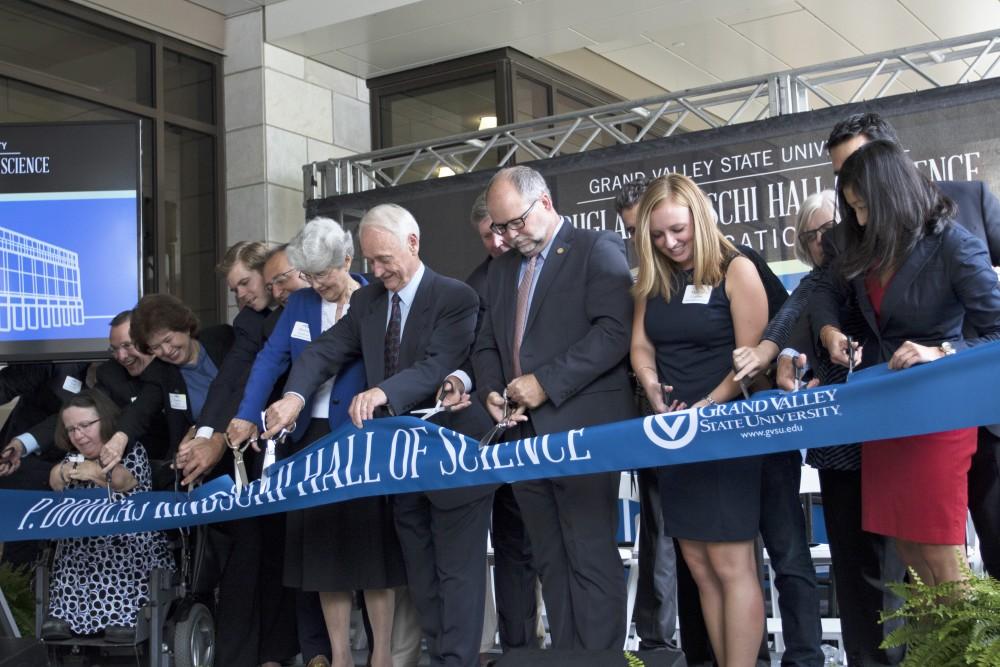 GVL / Kevin Sielaff
P. Douglas Kindschi and company cut the ribbon in front of the new Kindschi Hall of Science. Grand Valley celebrates the P. Douglas Kindschi Hall of Science with a dedication ceremony Friday, August 28th, 2015. The dedication recognized both Grand Valley and state officials that made the realization of this building possible. 