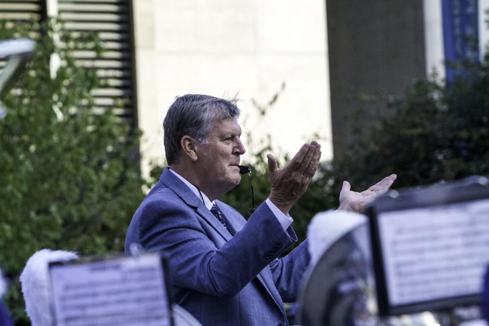 GVL / Sara Carte
Grand Valley’s President, Thomas J. Haas, leads the marching band with their fight song for the opening night of Art Prize in the Rosa Parks Circle on Sept. 23.