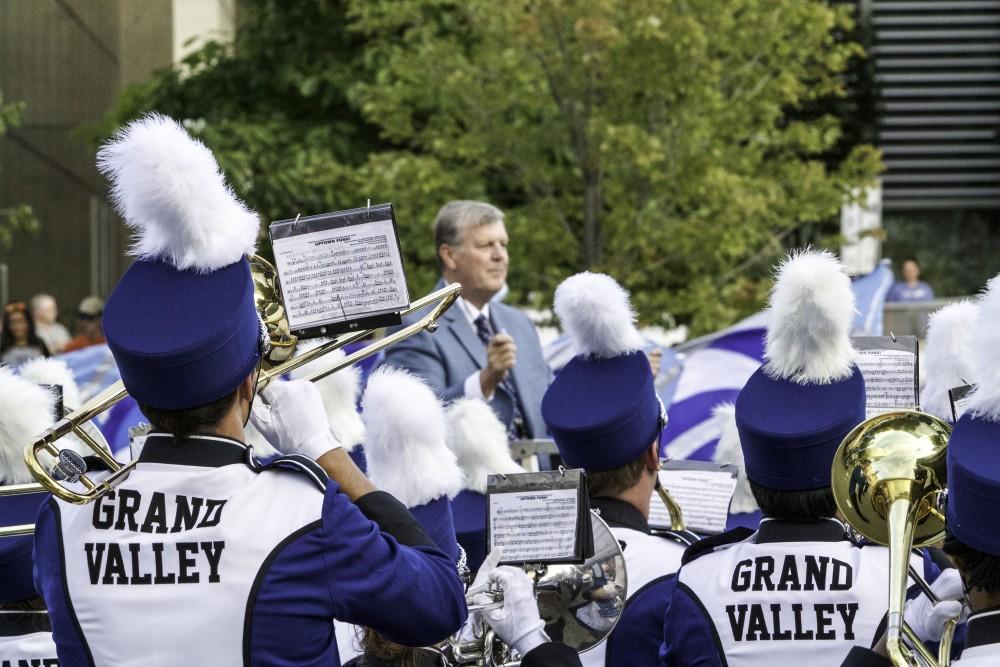 GVL / Sara Carte
Grand Valley’s President, Thomas J. Haas, leads the marching band with their fight song for the opening night of Art Prize in the Rosa Parks Circle on Sept. 23.