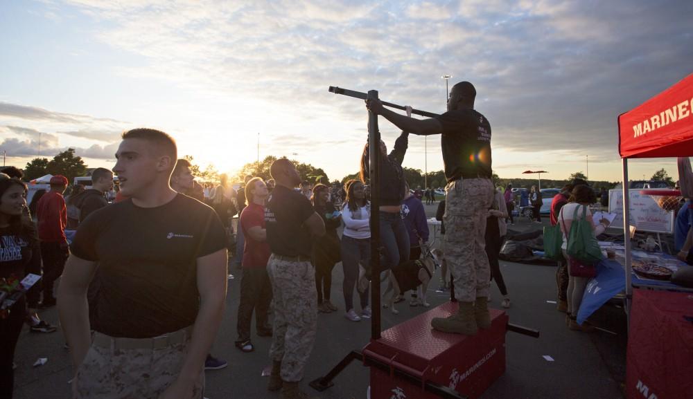 GVL/Kevin Sielaff
Students gather around the Marine Corps stand to try some pull-ups. Campus Life Night takes place Sept. 13 on the grounds of parking lot H at Grand Valley's Allendale campus. 