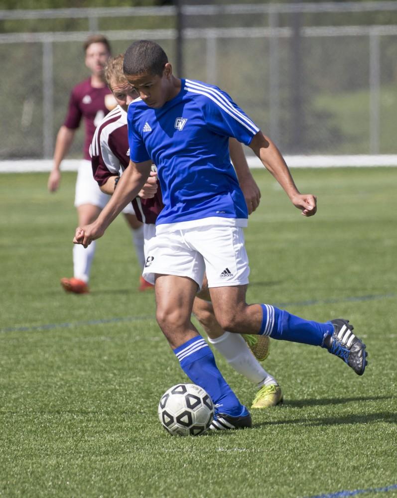 GVL/Kevin Sielaff
Corey Arthur-Fox drives the ball upfield. Grand Valley's club soccer team squares off against Central Michigan Sept. 12 at the intramural field. 