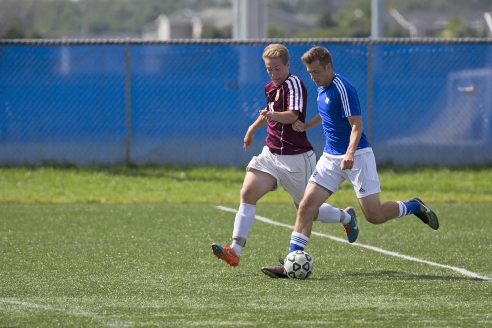 GVL/Kevin Sielaff
Jeremy Shane (9) moves the ball upfield. Grand Valley's club soccer team squares off against Central Michigan Sept. 12 at the intramural field. 