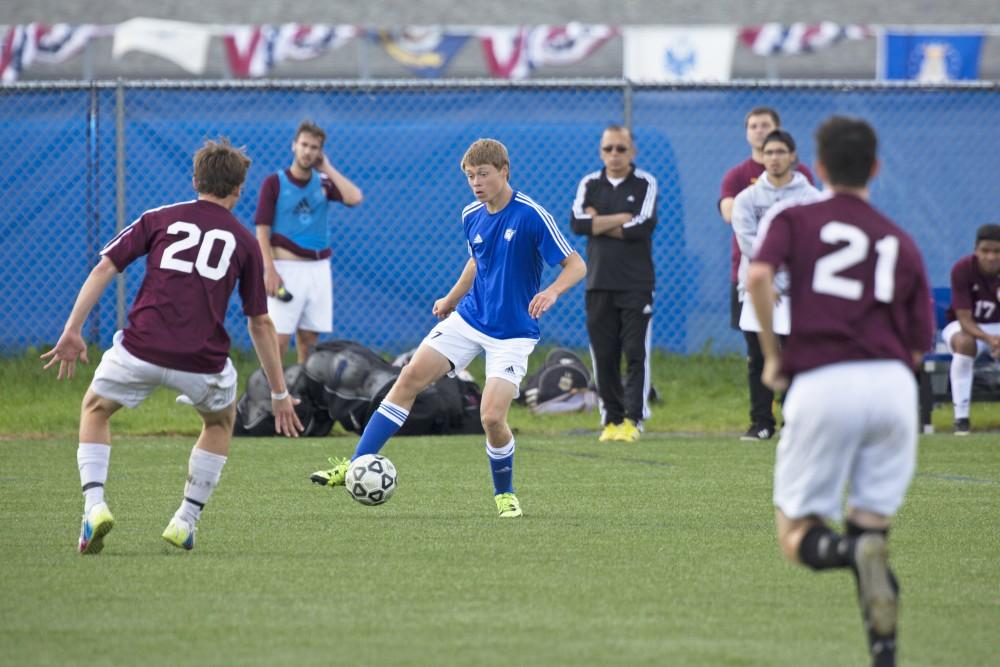 GVL/Kevin Sielaff
Noah Reiber dribbles around a defender. Grand Valley's club soccer team squares off against Central Michigan Sept. 12 at the intramural field. 