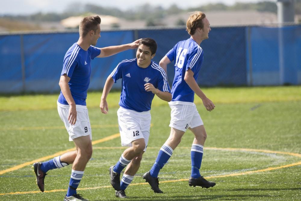 GVL/Kevin Sielaff
The team celebrates Casey Hagan's goal. Grand Valley's club soccer team squares off against Central Michigan Sept. 12 at the intramural field. 