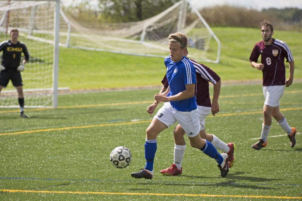 GVL/Kevin Sielaff
Chase Nielson dribbles toward the net. Grand Valley's club soccer team squares off against Central Michigan Sept. 12 at the intramural field. 