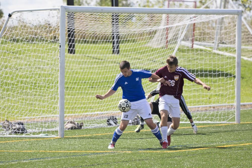 GVL/Kevin Sielaff
Robert Klein swivels the ball toward the net. Grand Valley's club soccer team squares off against Central Michigan Sept. 12 at the intramural field. 