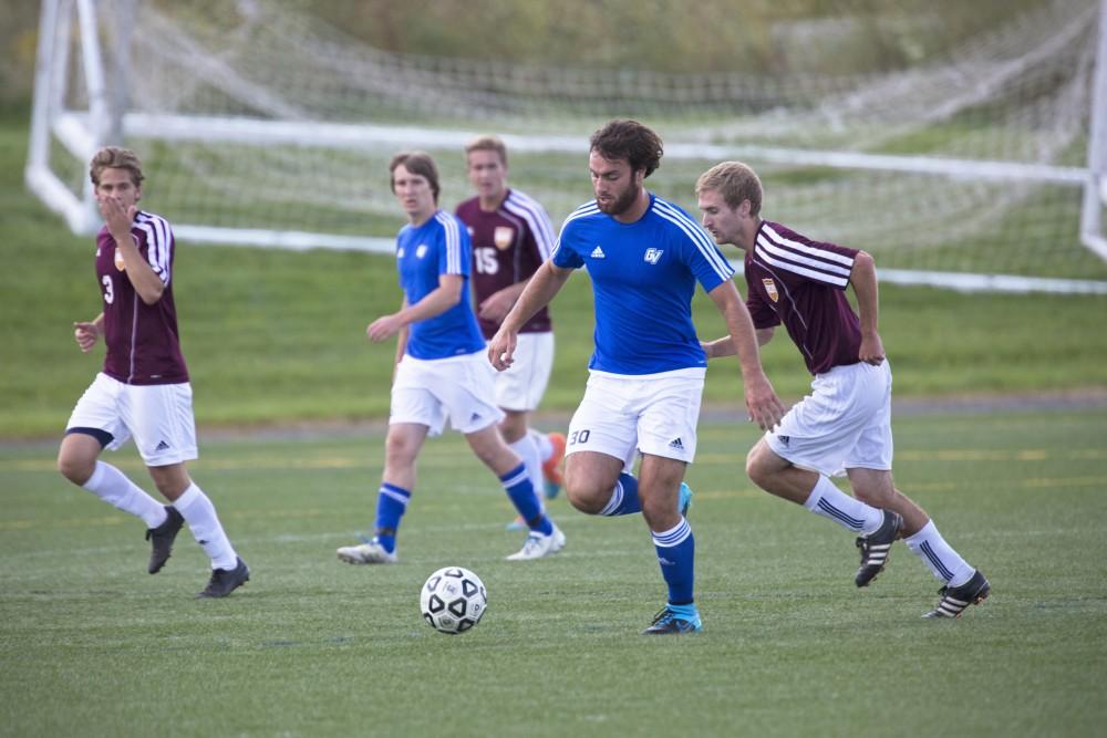 GVL/Kevin Sielaff
Paul Bump moves the ball upfield. Grand Valley's club soccer team squares off against Central Michigan Sept. 12 at the intramural field. 