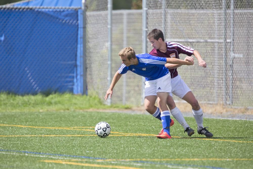 GVL/Kevin Sielaff
Justin Mohr pushes back a CMU forward. Grand Valley's club soccer team squares off against Central Michigan Sept. 12 at the intramural field. 