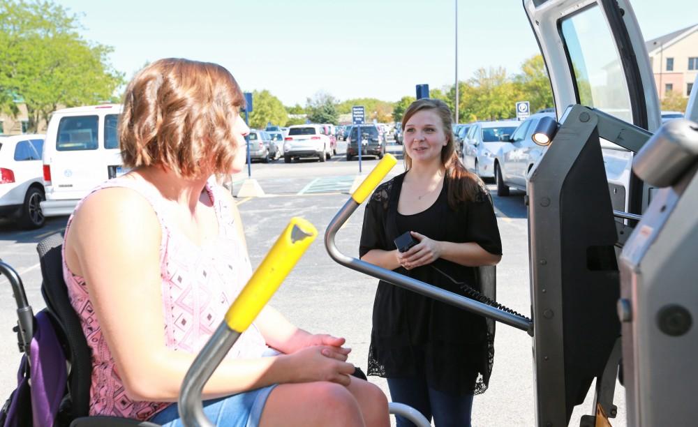 GVL/Kevin Sielaff 
Van operater Jenna Bud and student Sara Krahel use the van's lift on Sept. 23.