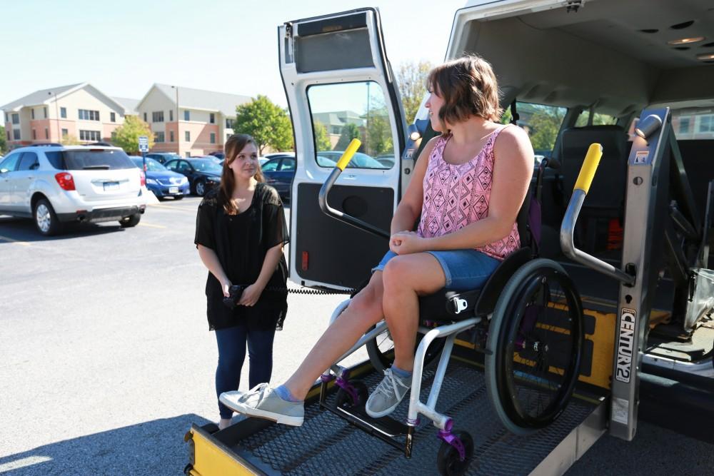 GVL/Kevin Sielaff 
Van operater Jenna Bud and student Sara Krahel use the van's lift on Sept. 23.