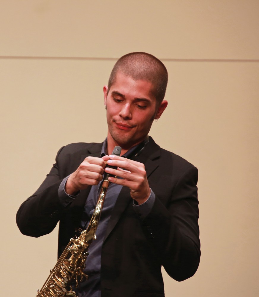 GVL / Kevin Sielaff
Joseph Girard, tenor saxophone, adjusts his mouthpiece on stage. The GVSU music department presents a faculty concert as a part of Fall Art Celebration Sept. 21 in the Louis Armstrong Theatre. 