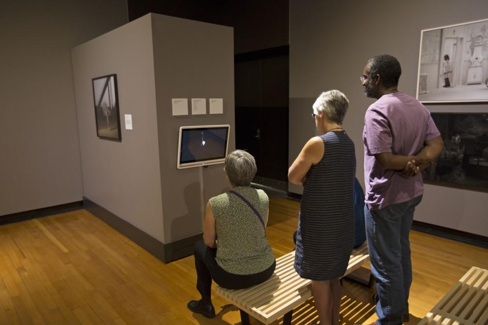 GVL/Kevin Sielaff
Spectators watch a live-action art piece on a television screen. The annual Fall Arts Celebration unveils the "Dusk to Dusk: Unsettled, Unraveled, Unreal" exhibit Sept. 10 inside the Performing Arts Center on Grand Valley's Allendale campus.