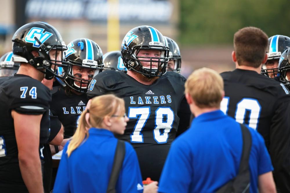 GVL / Kevin Sielaff 
Jim Walsh (78) joins a huddle during the game. Grand Valley State squares off against Southwest Baptist Thursday, September 3rd, 2015 at Lubbers Stadium. 